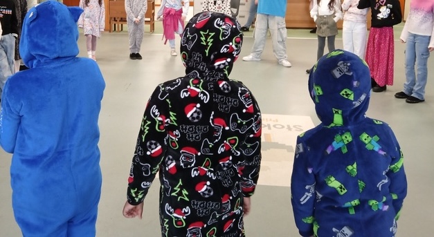 Pupils wear fleece onesies as part of an Energy Sparks 'Layer Up, Power Down' day