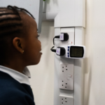 A primary school student looks at the read-out from an appliance energy monitor.
