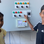 Two primary students help switch the boiler off for the holiday