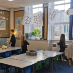 Pupils at one of Aspire Academy Trust's schools investigate whether windows are being left open while the heating is on.