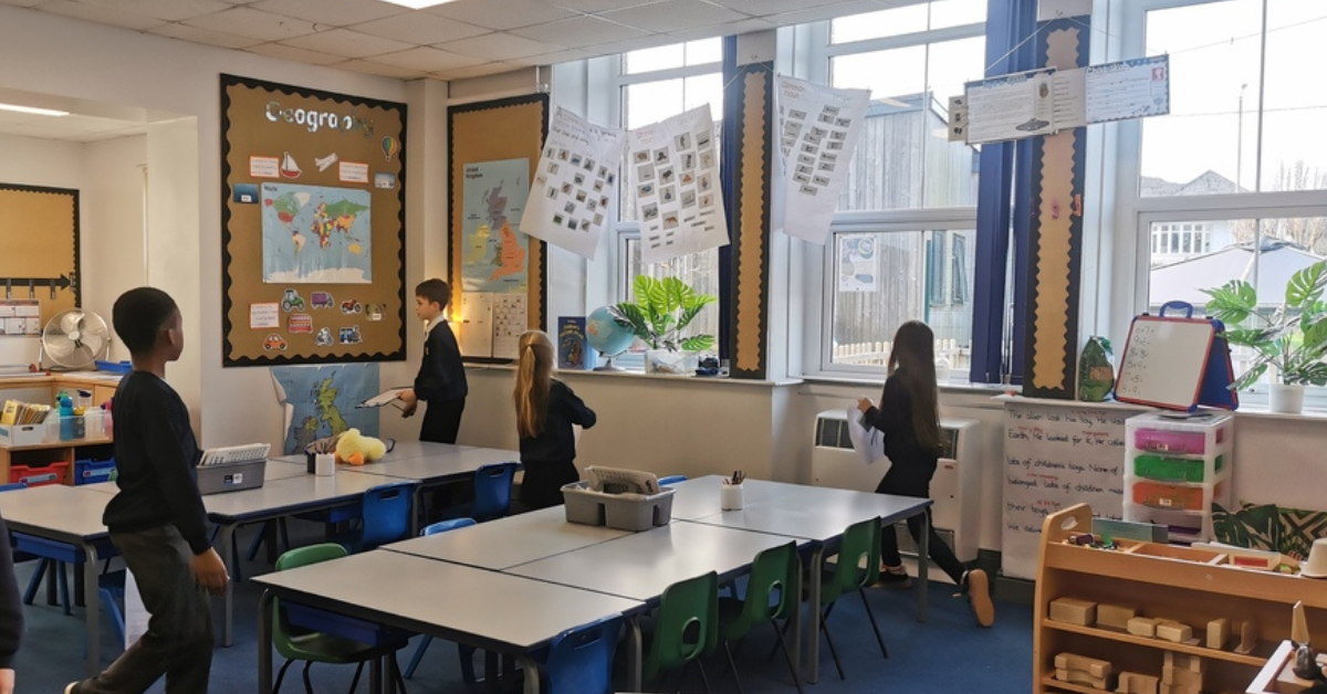 Pupils at one of Aspire Academy Trust's schools investigate whether windows are being left open while the heating is on.